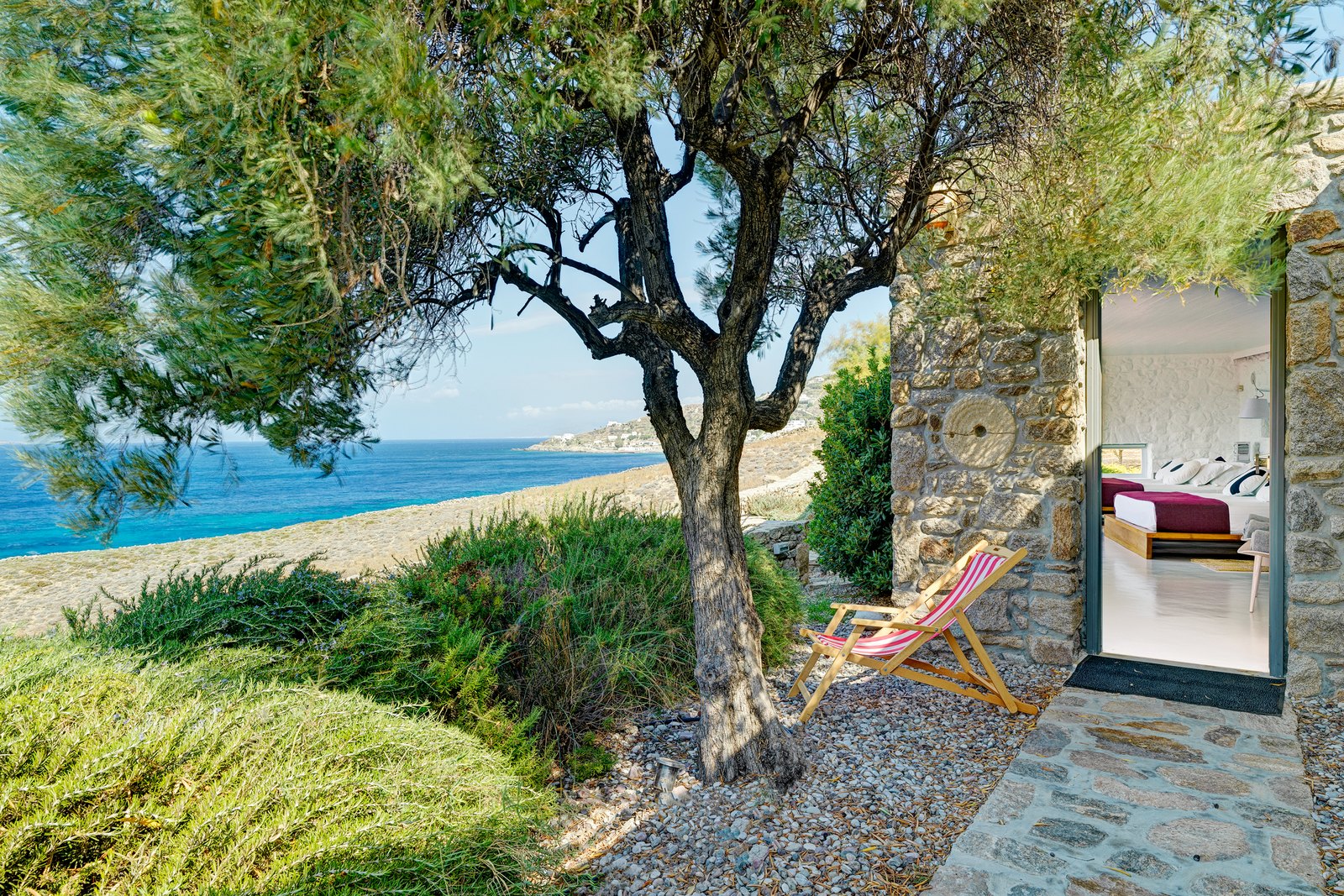 Tree-shaded entrance to a guest bedroom above the beach
