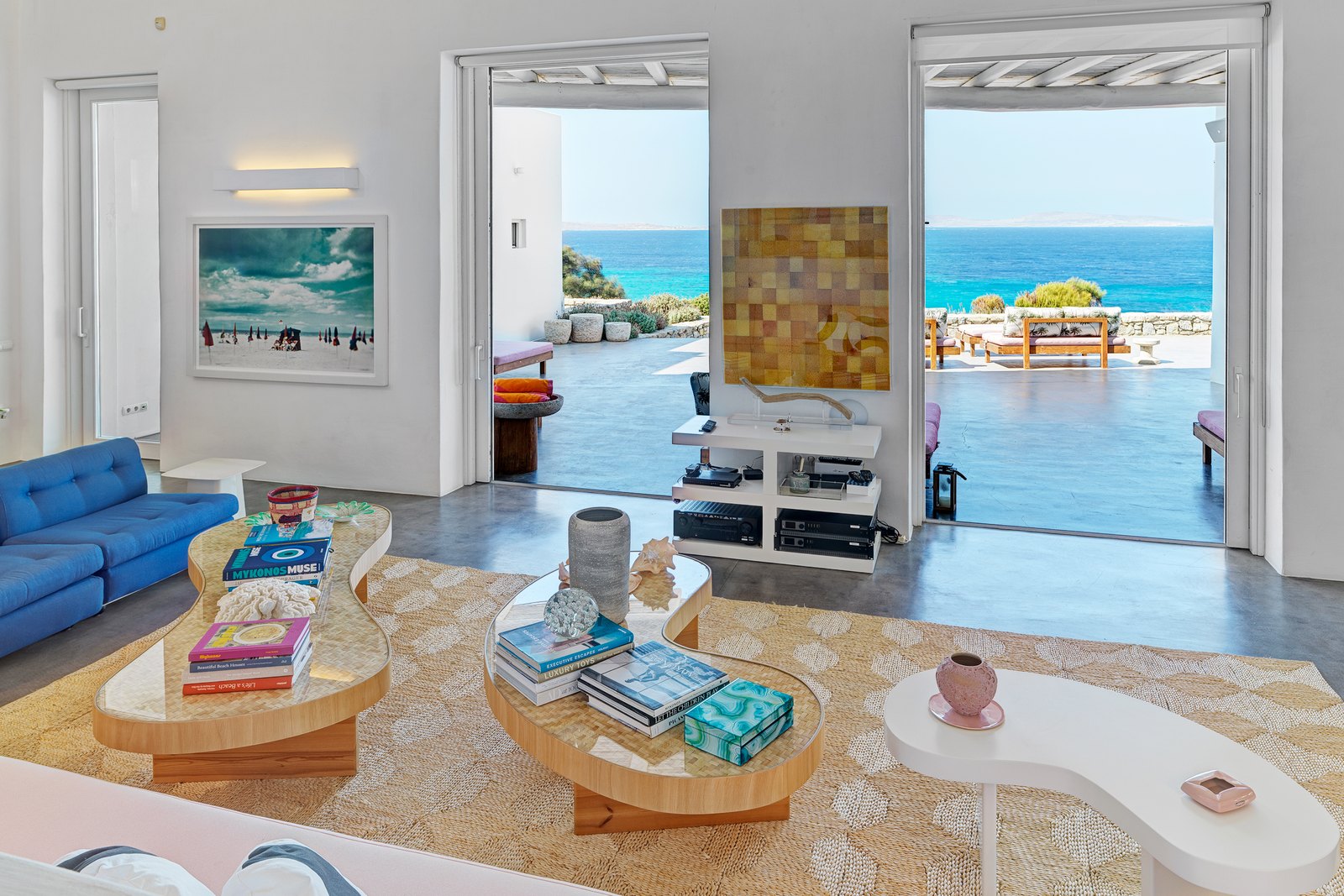 Living room opening to the pool terrace and the sea